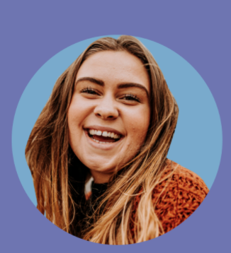A smiling person with long hair, wearing a jumper, framed in a circular border against a solid color background.